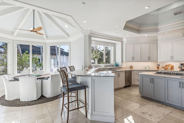 kitchen with ceiling fan, a center island, ornamental molding, and stainless steel appliances