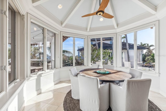 sunroom / solarium with vaulted ceiling with beams, a healthy amount of sunlight, and ceiling fan