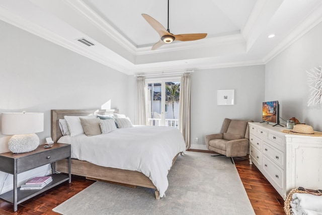 bedroom with a raised ceiling, ceiling fan, dark hardwood / wood-style flooring, and crown molding