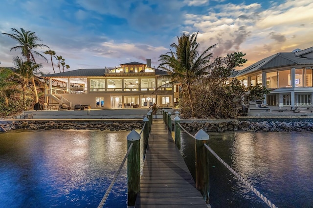 view of dock featuring a balcony and a water view