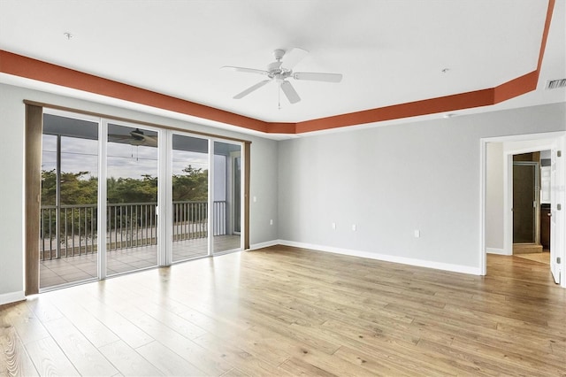 spare room with light wood-type flooring and ceiling fan