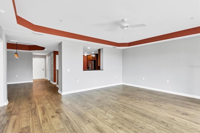 empty room featuring ceiling fan and light hardwood / wood-style flooring