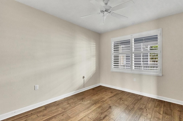 unfurnished room with ceiling fan and wood-type flooring