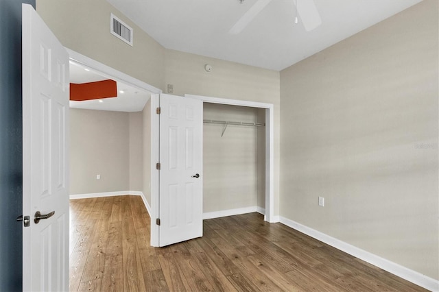 unfurnished bedroom featuring a closet, ceiling fan, and hardwood / wood-style flooring