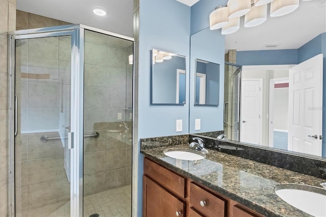 bathroom with walk in shower and vanity