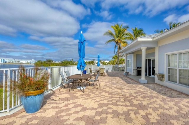 view of patio with a water view and area for grilling