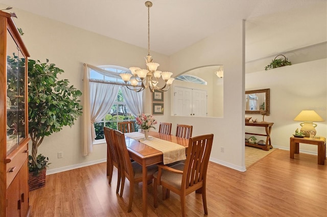 dining room featuring light hardwood / wood-style flooring and an inviting chandelier