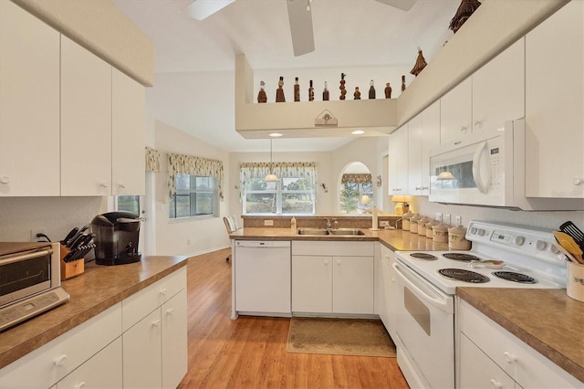 kitchen with sink, white cabinets, white appliances, and light wood-type flooring