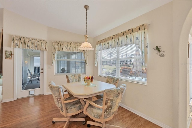 dining space with hardwood / wood-style floors and lofted ceiling