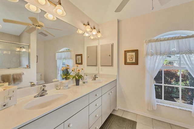 bathroom with tile patterned floors, plenty of natural light, toilet, and a shower with shower door