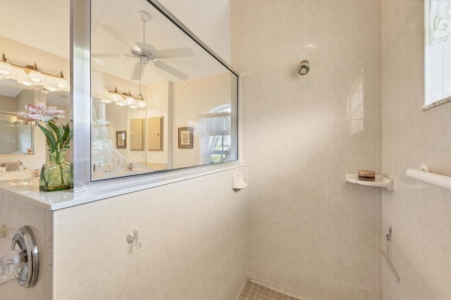 bathroom with ceiling fan and tiled shower