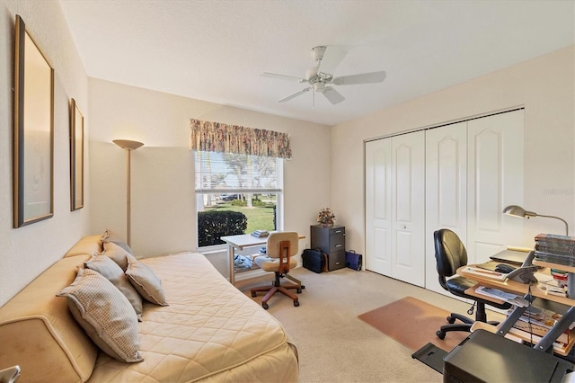 carpeted bedroom with a closet and ceiling fan