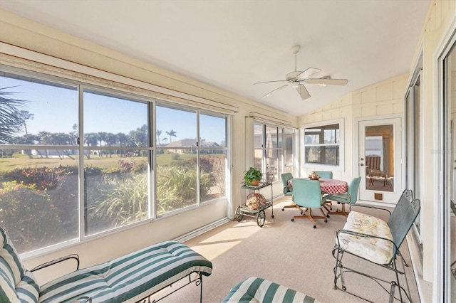 sunroom / solarium with ceiling fan and vaulted ceiling