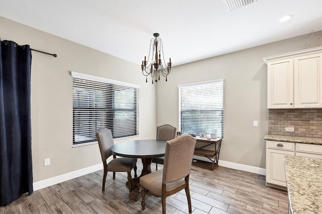 dining area featuring a chandelier and light hardwood / wood-style floors