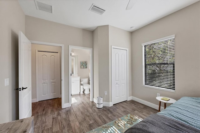 bedroom featuring wood-type flooring, ensuite bath, and ceiling fan