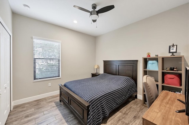 bedroom featuring ceiling fan, a closet, and light hardwood / wood-style floors