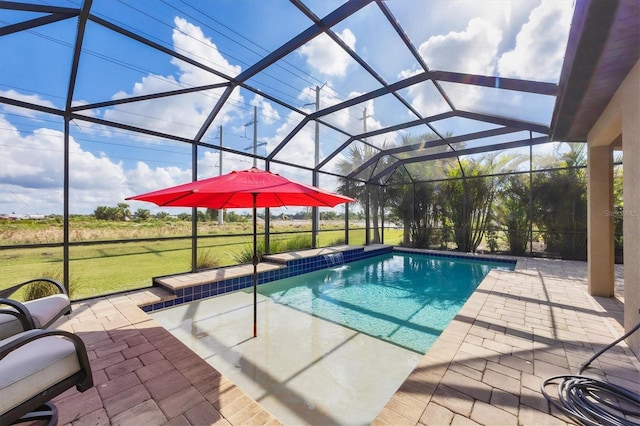 view of pool with a lawn, glass enclosure, and a patio