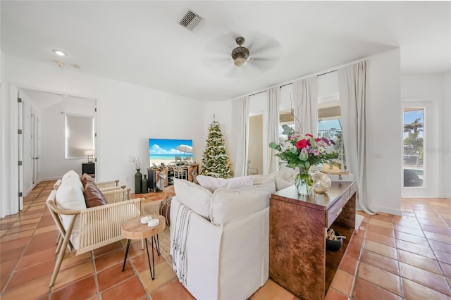 tiled living room featuring ceiling fan