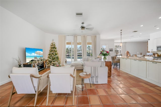 tiled living room featuring ceiling fan