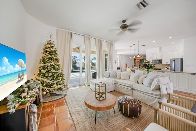 tiled living room featuring ceiling fan