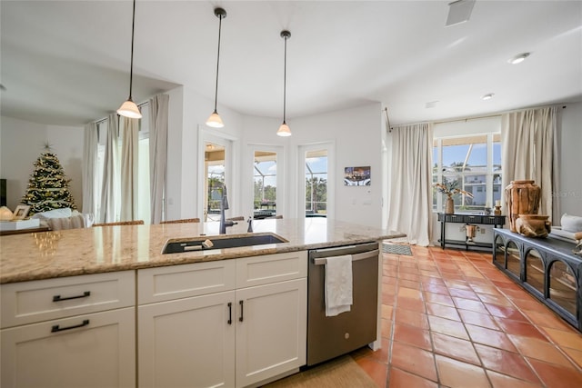 kitchen with dishwasher, white cabinets, plenty of natural light, and sink