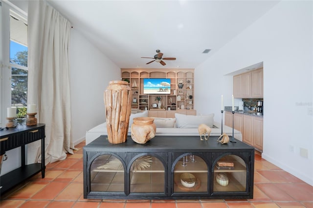 tiled living room featuring ceiling fan