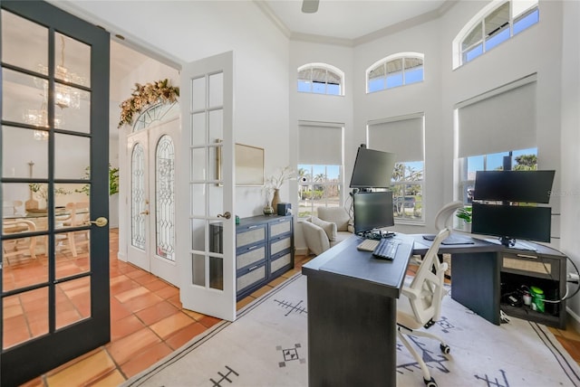 office space featuring french doors, hardwood / wood-style flooring, crown molding, and a high ceiling