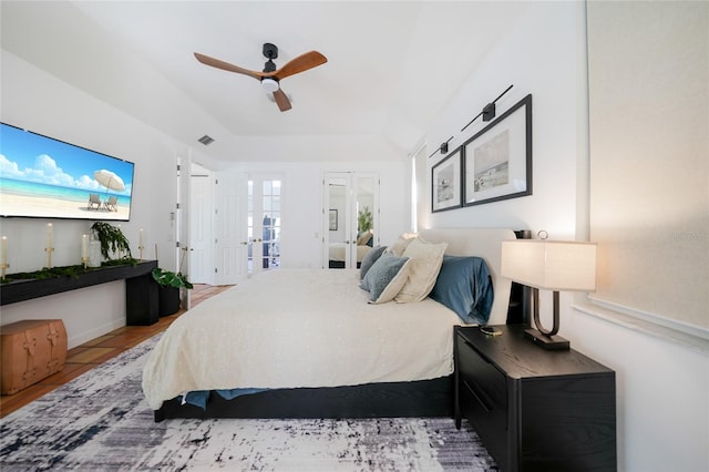 tiled bedroom featuring french doors and ceiling fan