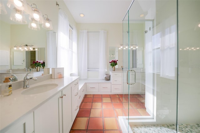 bathroom with tile patterned flooring, vanity, and a shower with door