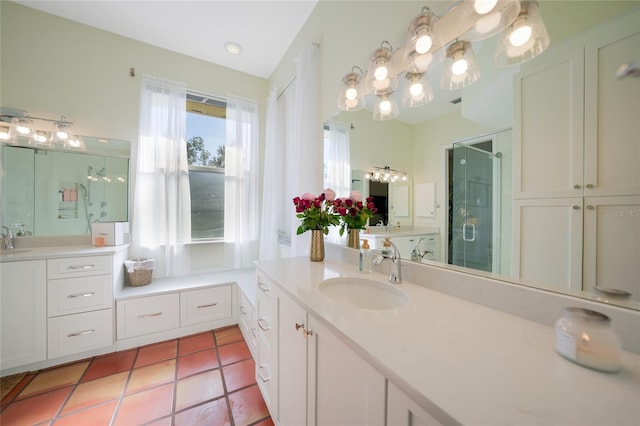 bathroom featuring tile patterned floors, vanity, and a shower with door