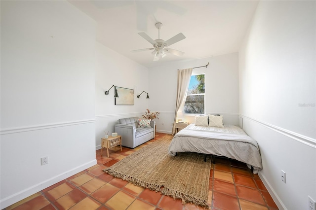 tiled bedroom featuring ceiling fan