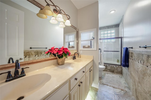 full bathroom featuring vanity, bath / shower combo with glass door, and toilet