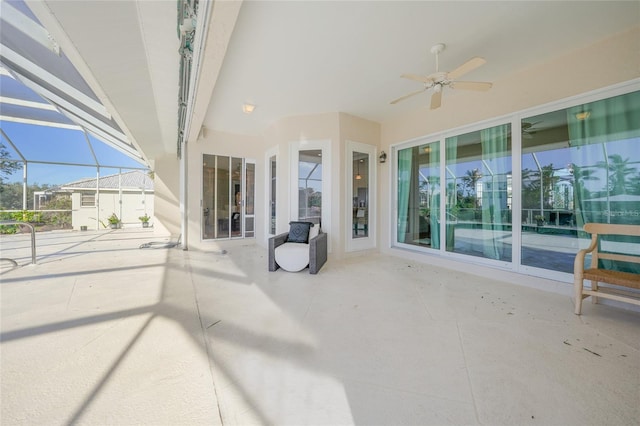 view of patio / terrace with ceiling fan and a lanai