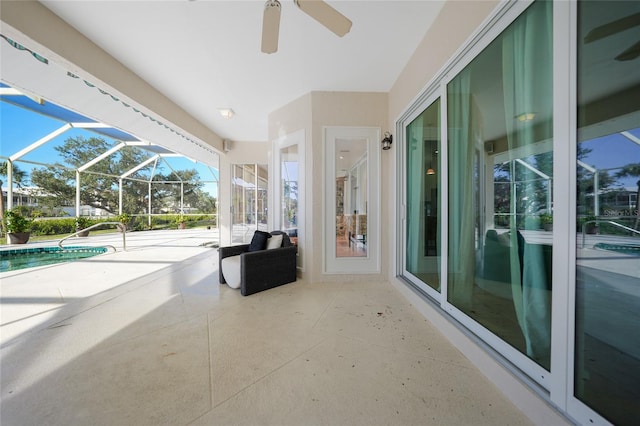 view of patio with glass enclosure and ceiling fan