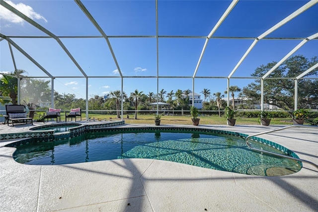 view of pool featuring an in ground hot tub, a patio area, and a lanai