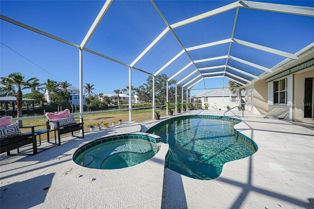 view of swimming pool with glass enclosure, an in ground hot tub, and a patio