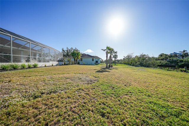 view of yard with glass enclosure