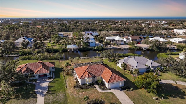 aerial view at dusk with a water view