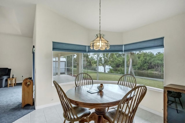 tiled dining room with a notable chandelier