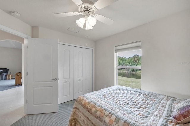 bedroom with ceiling fan and a closet