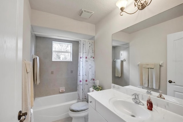 full bathroom featuring tile patterned floors, a textured ceiling, vanity, shower / bath combo with shower curtain, and toilet