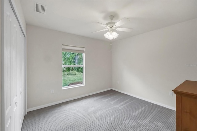 carpeted spare room with ceiling fan