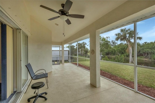 unfurnished sunroom with ceiling fan and plenty of natural light