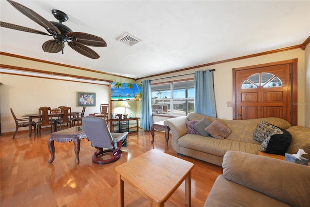 living room featuring ceiling fan, crown molding, and light hardwood / wood-style flooring