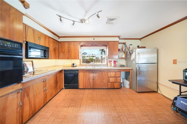 kitchen featuring sink, light parquet floors, ornamental molding, and black appliances