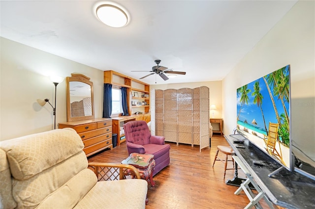 living room with ceiling fan and wood-type flooring