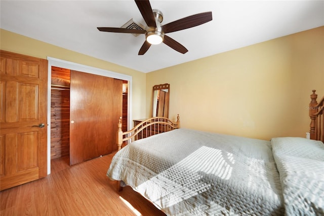 bedroom featuring ceiling fan, light wood-type flooring, and a closet