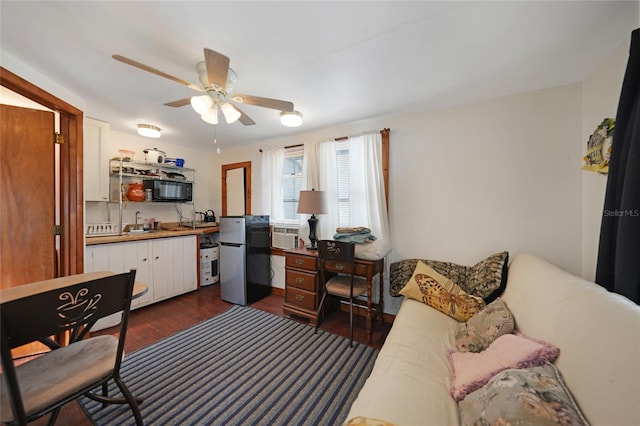 interior space with ceiling fan, dark hardwood / wood-style flooring, and sink