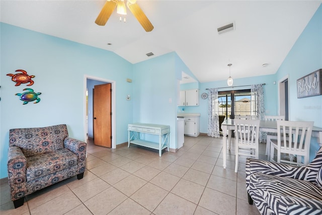 living room with ceiling fan, lofted ceiling, and light tile patterned flooring