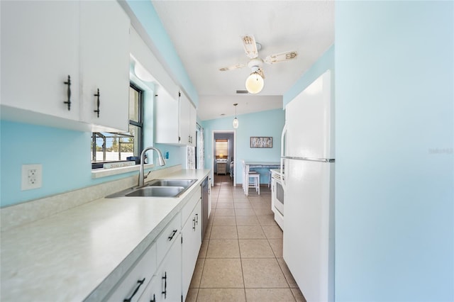 kitchen with sink, pendant lighting, white cabinets, white fridge, and lofted ceiling